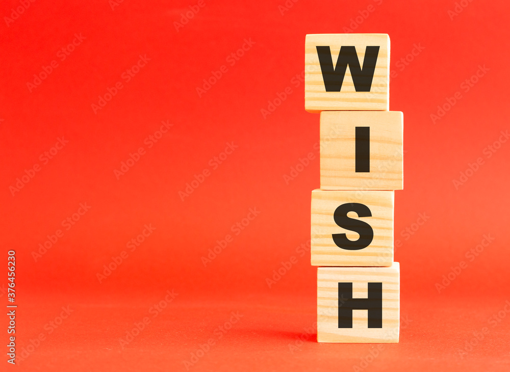 Wooden cubes with letters. For your design, concept. Wooden cubes on a red background. Free space on the left. Wooden cubes with letters. For your design, concept. Wooden cubes on a red background. Free space on the left.