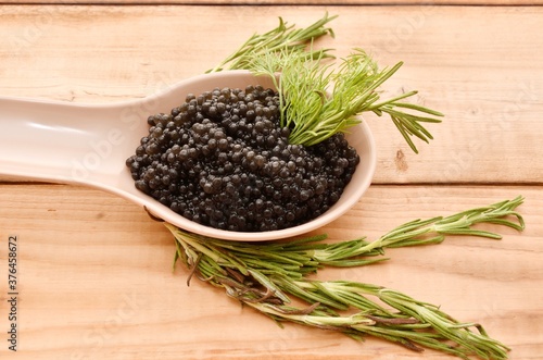 Black caviar with fresh herbs