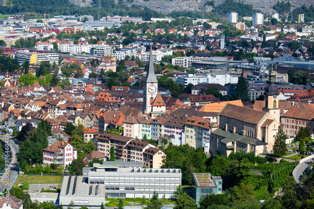 Aerial view of Chur townscape overlooking reformed church of St. Martin and Catholic Cathedral on summer day, canton of Graubunden, Switzerland..