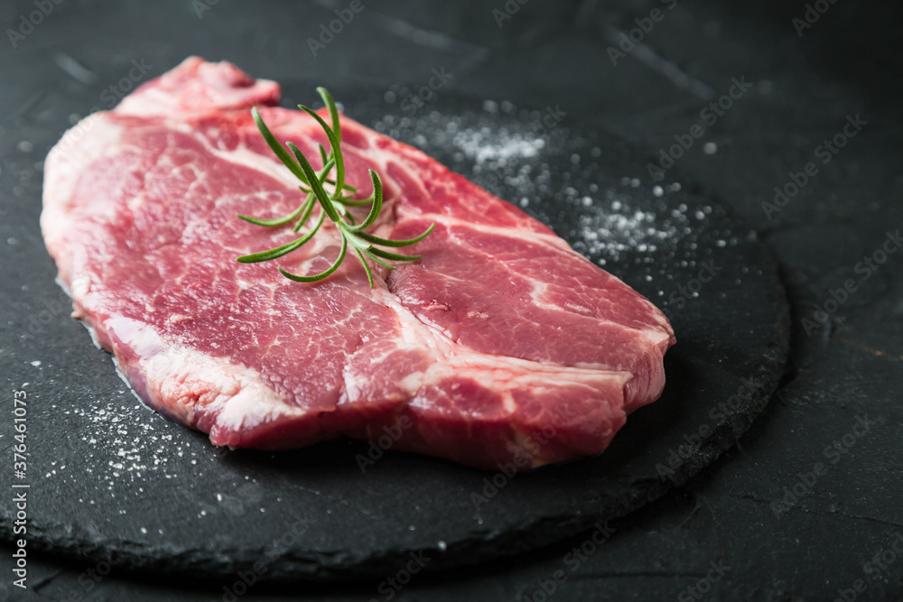 Fresh marbled beef steak on dark background