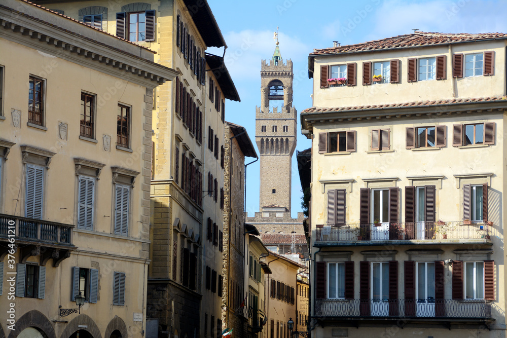 The historic buildings of Piazza Santa Croce in Florence and in the background the tower of Arnolfo overlooking Palazzo Vecchio in Piazza della Signoria.