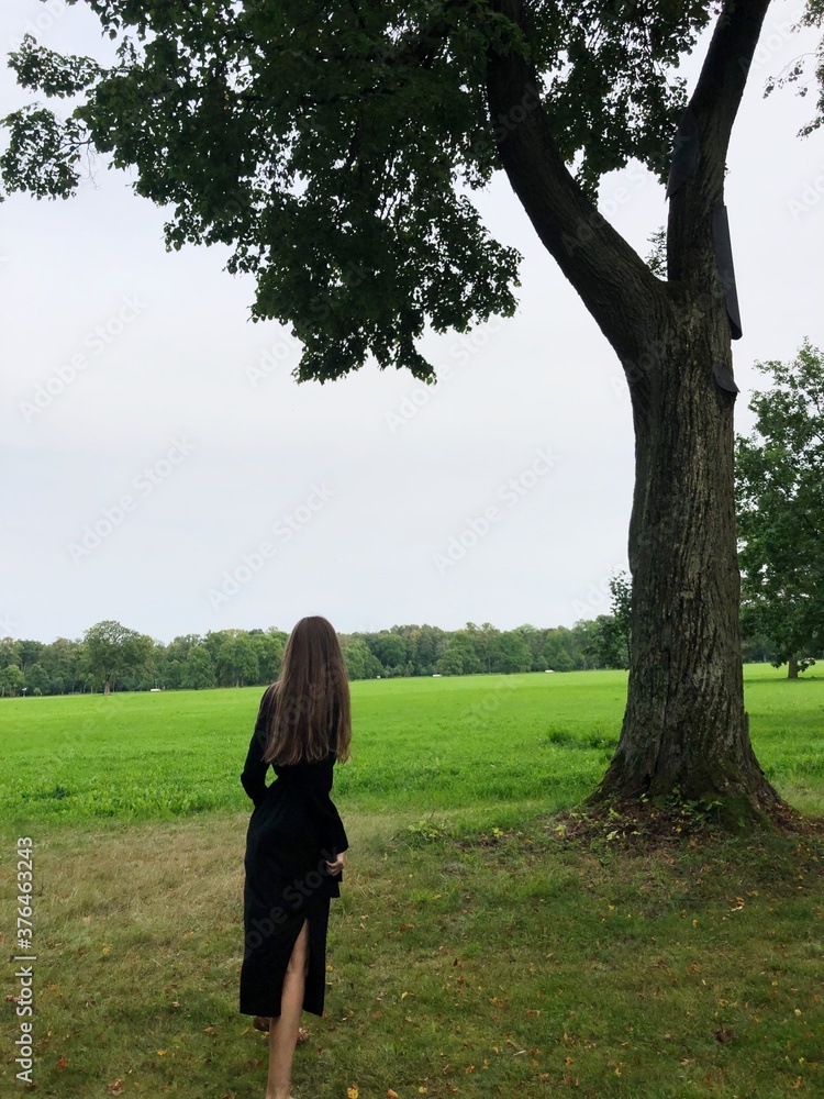 Girl in a black dress in the Park