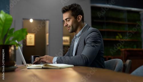 Young businessman working on a laptop at his office desk
