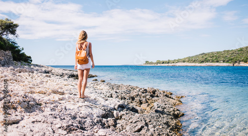 Anonymous woman standing on seashore