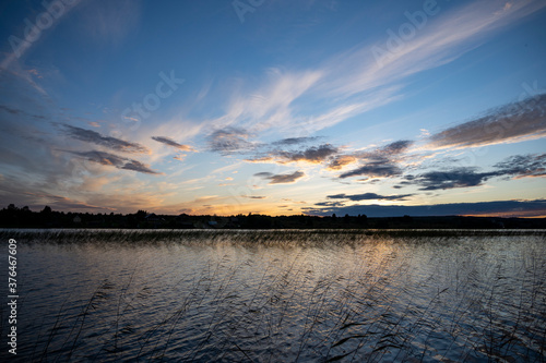 sunrise over the lake when the sky is covered with rain clouds