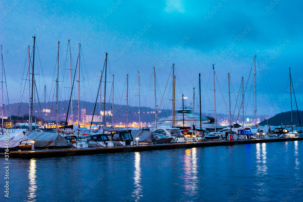 Harbour with yachts in downtown of Oslo at Oslofjord sea waterfront. Evening seascape.