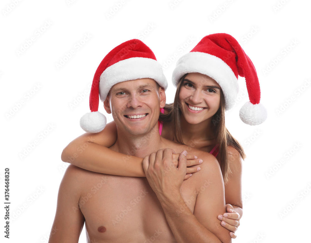 Happy couple with Santa hats together on white background. Christmas vacation Happy couple with Santa hats together on white background. Christmas vacation