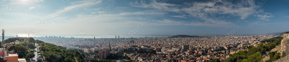 Wide panorama of Barcelona, Spain, viewed from the Bunkers of Carmel on a sunny day with blue skies. Picturesque panorama of morning Barcelona.