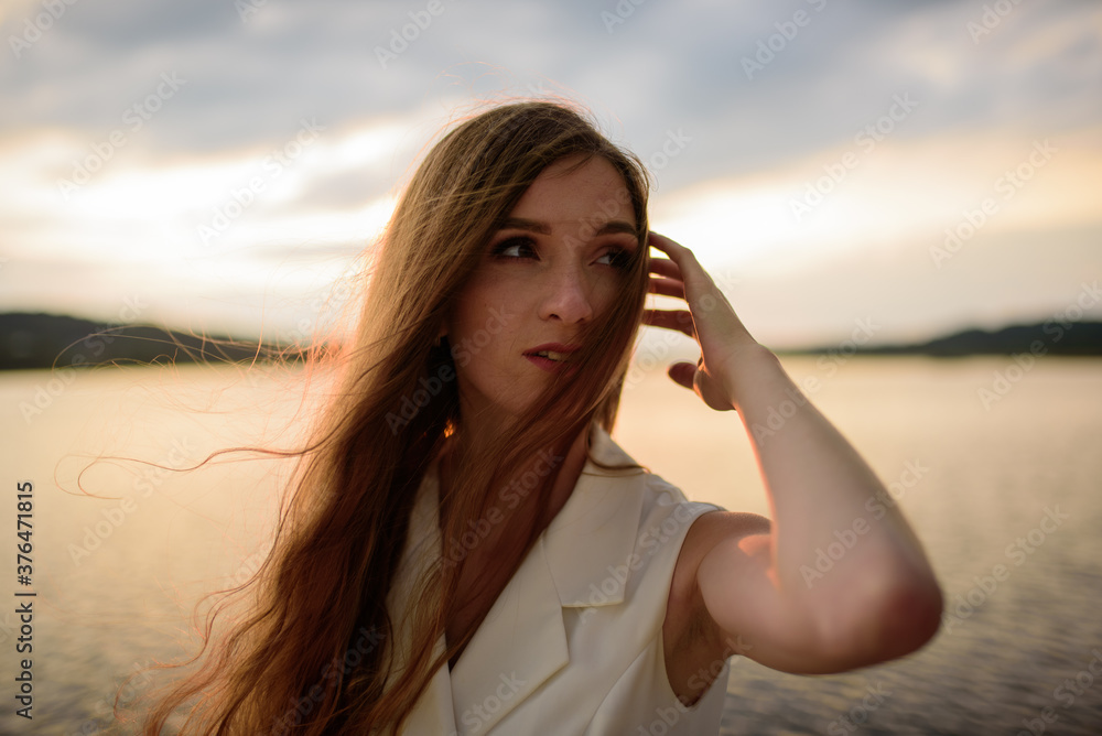 Portrait of a beautiful girl during sunset before a thunderstorm.