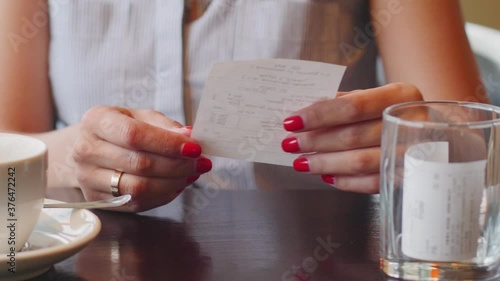 NFC technology. Close-up of young woman using credit card with NFC chip on bank terminal. Customer paying for food order outdoor. Detail of a client hands paying with the contactless credit card.