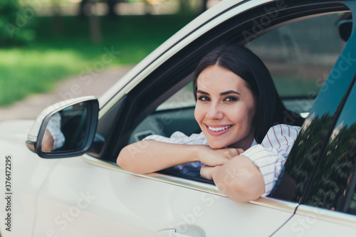Close-up portrait of her she nice attractive gorgeous lovely pretty cheerful content lady enjoying riding cool white vehicle motorway good mood suburb way road