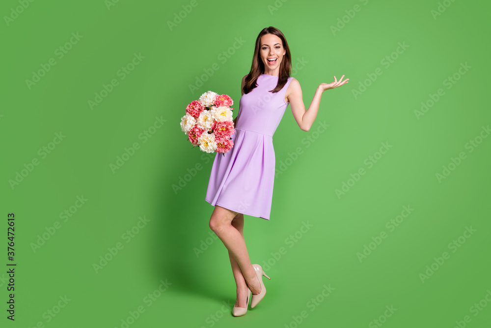 Full length body size view of her she nice-looking attractive pretty lovely charming cheerful cheery girl holding in hands bunch fresh flowers having fun isolated green color background Full length body size view of her she nice-looking attractive pretty lovely charming cheerful cheery girl holding in hands bunch fresh flowers having fun isolated green color background