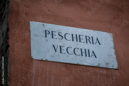 Sign on the wall with the name "Old fish market" on the wall in Verona, Veneto, Italy