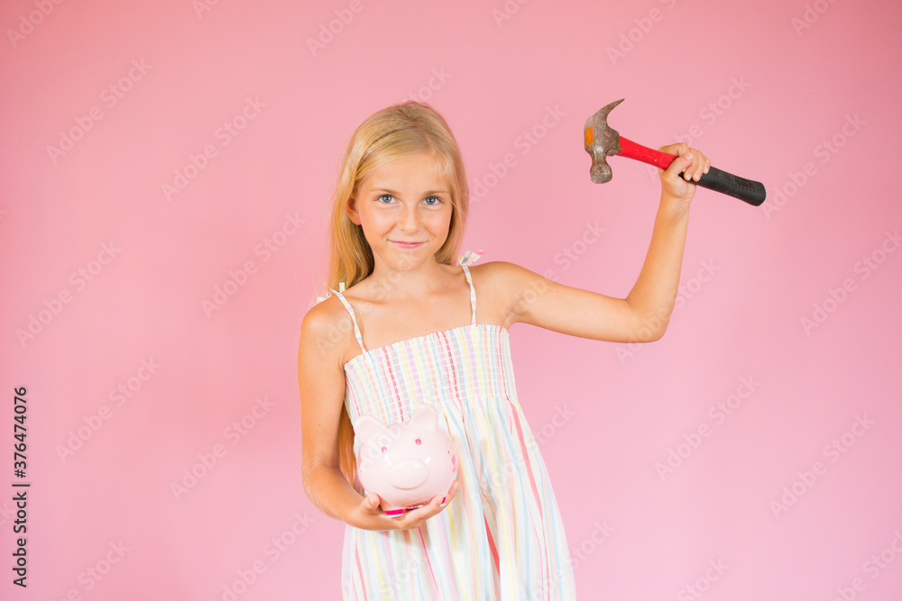 Blonde girl with a piggy bank and a hammer Blonde girl with a piggy bank and a hammer