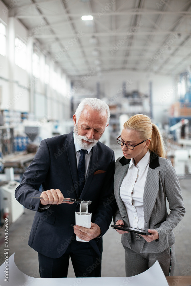 Man and woman discussing work. Colleagues working in factory. Man and woman discussing work. Colleagues working in factory.