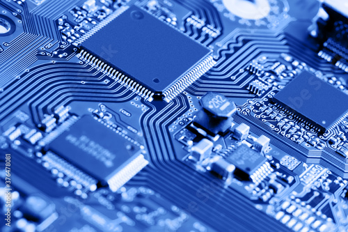 Canvas Print Electronic circuit board close up. Blue background.