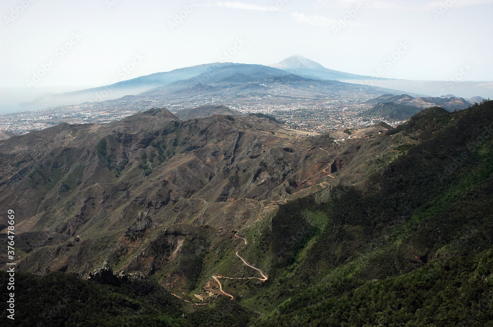 View towards Mount Teide from Pico Ingles, in Anaga Mountains, high altitude panoramic clear perspective spreading over mountains, ravines, forests, towns and villages, Tenerife, Canary Islands, Spain