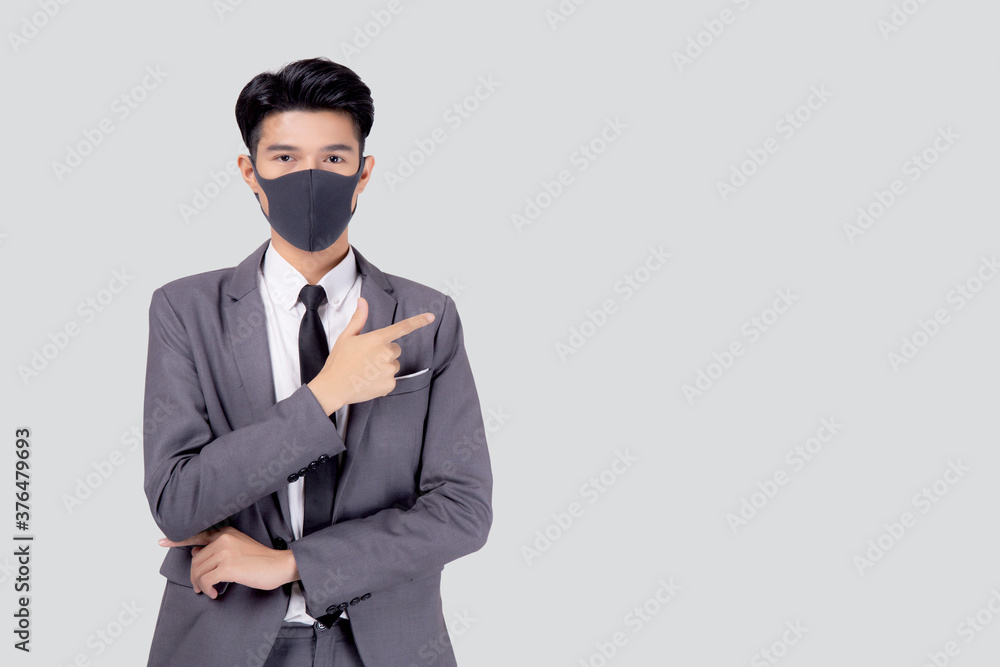 Portrait young asian businessman in suit wearing face mask for protective covid-19 isolated on white background, business man presenting and showing, quarantine for pandemic coronavirus, new normal. Portrait young asian businessman in suit wearing face mask for protective covid-19 isolated on white background, business man presenting and showing, quarantine for pandemic coronavirus, new normal.
