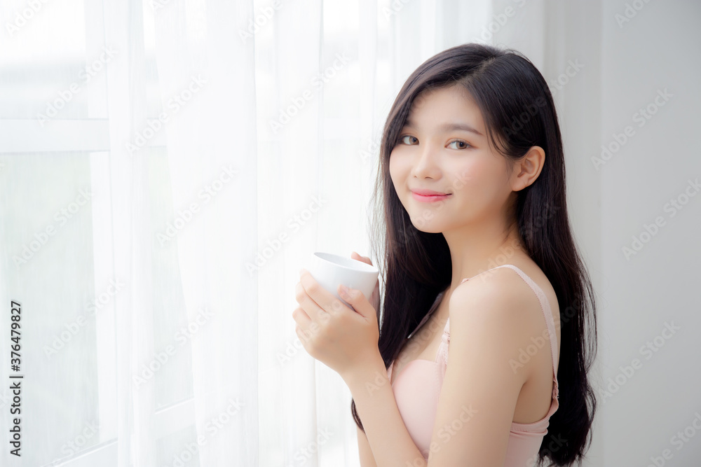 Beautiful young asian sexy woman in underwear drinking coffee near windows in the morning, girl with seductive figure fit drinking beverage for relax and resting after wake up, lifestyle concept. Beautiful young asian sexy woman in underwear drinking coffee near windows in the morning, girl with seductive figure fit drinking beverage for relax and resting after wake up, lifestyle concept.
