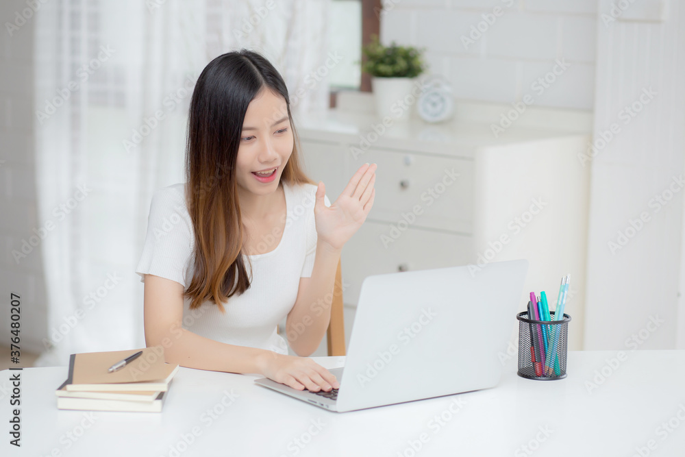 Young asian business woman using laptop computer for video call online hello and communicate work from home, girl conference with notebook and say hi, social distancing, communication concept. Young asian business woman using laptop computer for video call online hello and communicate work from home, girl conference with notebook and say hi, social distancing, communication concept.