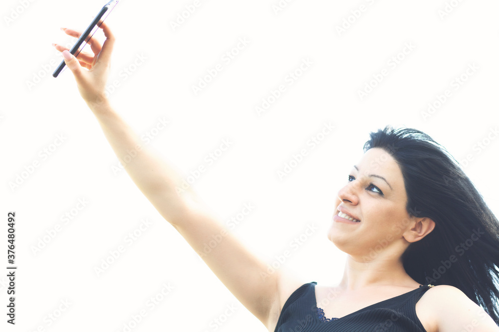 Pretty young happy woman making selfie on smartphone Pretty young happy woman making selfie on smartphone