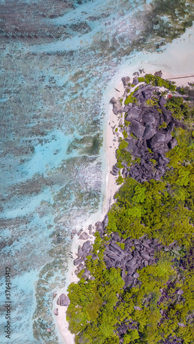 Anse Source Argent, La Digue. Downward aerial view of tropical coastline and granite rocks