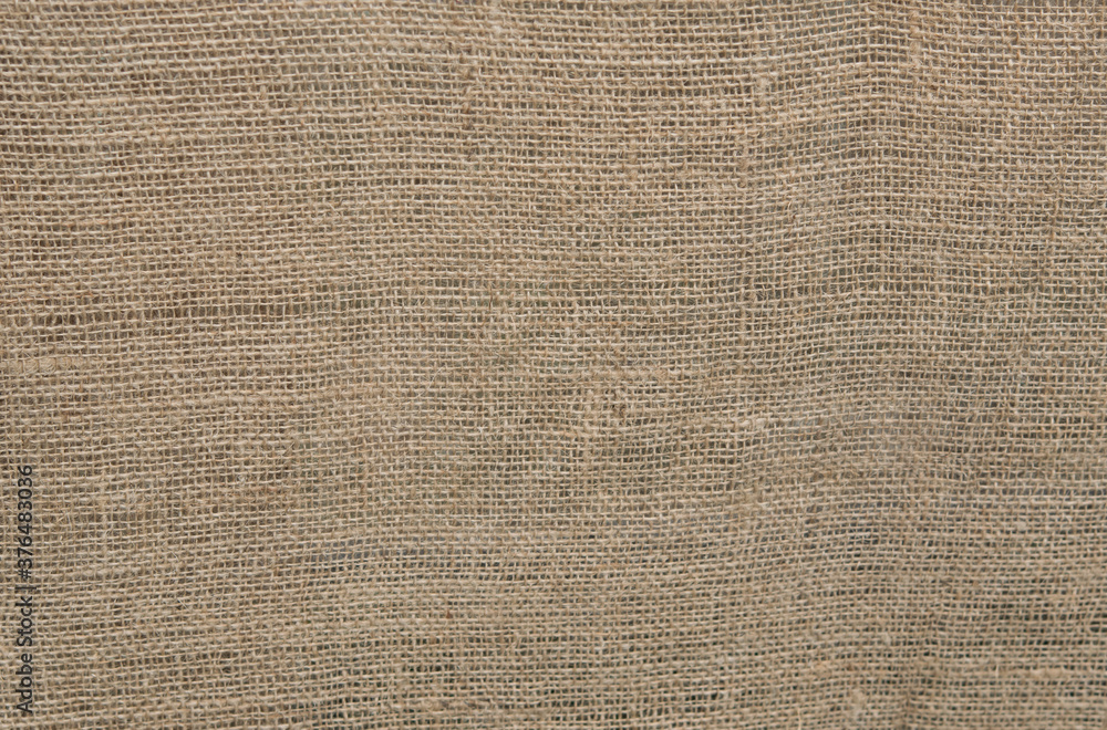 Close-up of sackcloth or burlap woven fabric texture for backdrop and background with copy space for text. Close-up of sackcloth or burlap woven fabric texture for backdrop and background with copy space for text.
