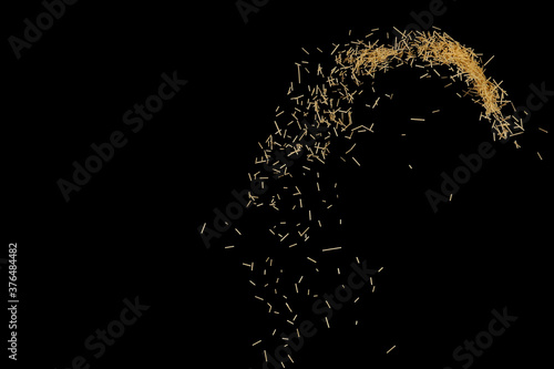 Flying pasta isolated on black background. Abstract macaroni falling.
