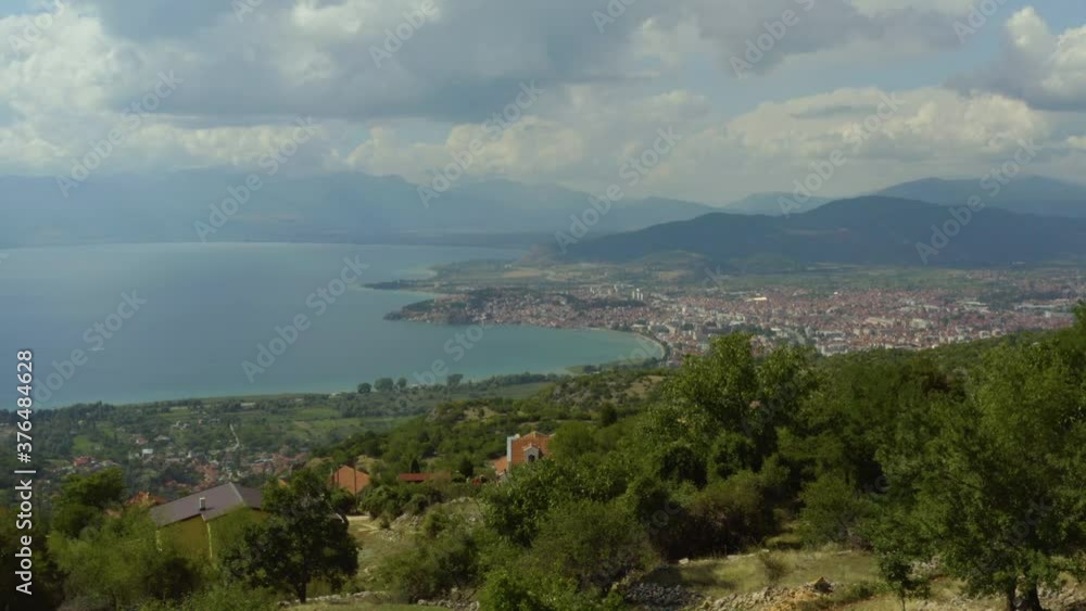 The drone flies over the mountains with peaks, rocks and landscape, which overlooks Lake Ohrid with the sun's rays over it and the city with its houses and streets. Aerial shot of Macedonia.
The drone flies over the mountains with peaks, rocks and landscape, which overlooks Lake Ohrid with the sun's rays over it and the city with its houses and streets. Aerial shot of Macedonia.