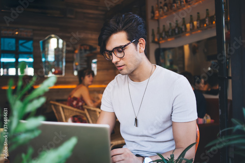 Busy guy surfing internet with computer