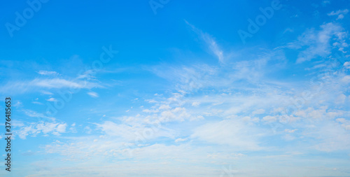 White clouds in the blue sky. Light heavenly background. Natural background.