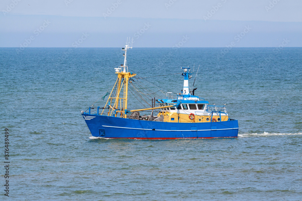 A shrimp trawler fishing along the beach of Wassenaar, Netherlands A shrimp trawler fishing along the beach of Wassenaar, Netherlands
