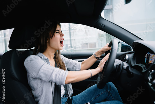 Angry young woman driving car © BullRun