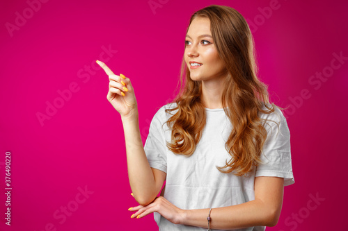 Portrait charming pretty cheerful girl showing copy space