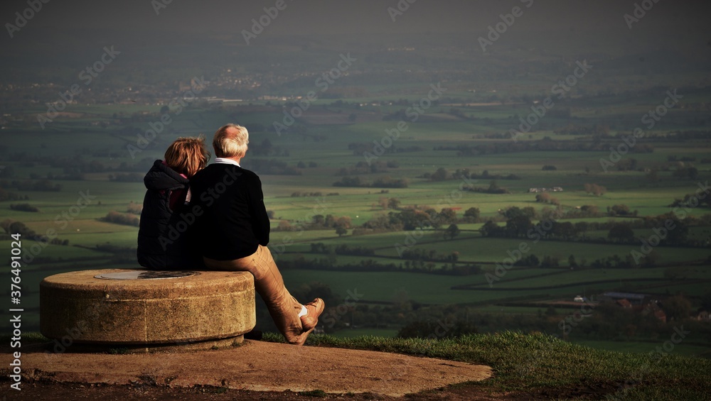 couple sitting on a bench with vieew