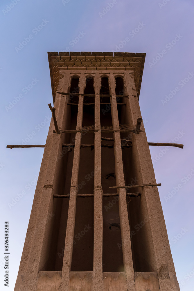 Big sandy wind Tower building with sticks in Yazd from below, Iran.