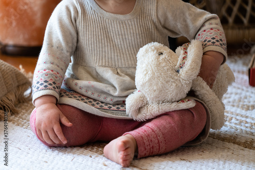 Child playing with a stuffed animal bunny toy