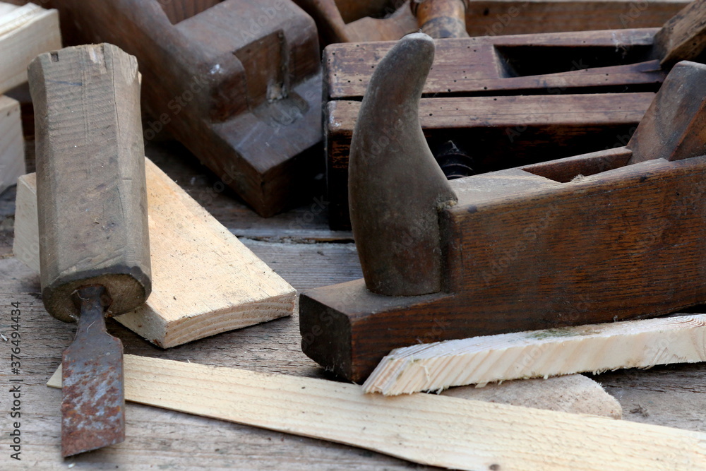 Old wooden carpenter's planes on a wooden background. Still life with old carpenter's planes Old wooden carpenter's planes on a wooden background. Still life with old carpenter's planes