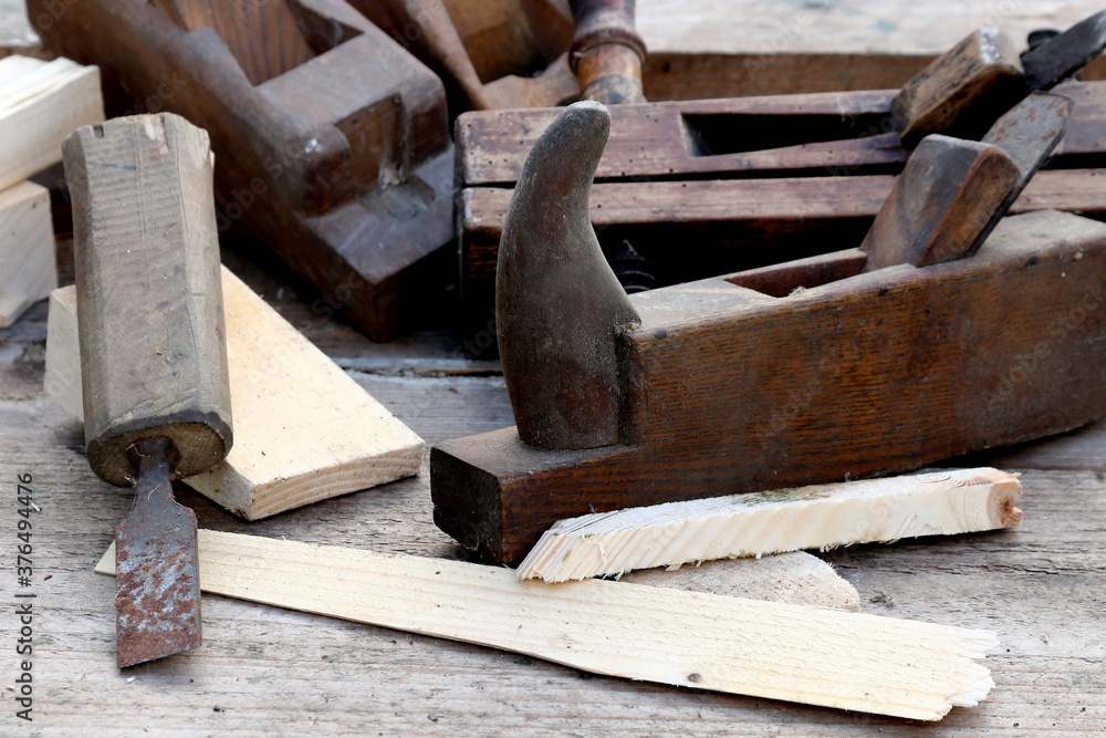 Old wooden carpenter's planes on a wooden background. Still life with old carpenter's planes Old wooden carpenter's planes on a wooden background. Still life with old carpenter's planes