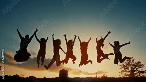Group of Young People Jumping at the Sunset photo