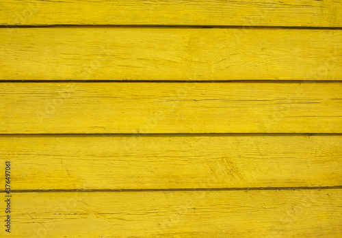 A wooden background made of yellow planks, a place for text.
