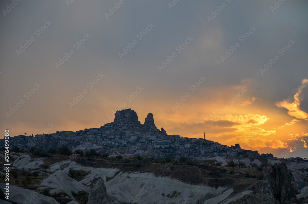 The view on fairy sunset over Uchisar rock castle, with amazing rock formations Cappadocia, Turkey The view on fairy sunset over Uchisar rock castle, with amazing rock formations Cappadocia, Turkey