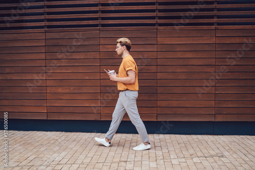 Man walking against wooden street wall © BullRun