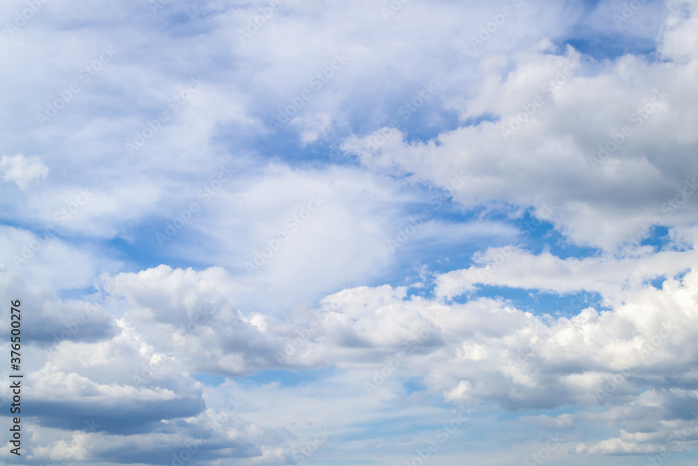 The blue sky shines through the clouds. Many white clouds on a sunny day. Natural background... The blue sky shines through the clouds. Many white clouds on a sunny day. Natural background...