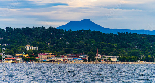 view of Burlington, Vermont waterfront from a sail boat on Lake Champlain with Camel's Hump mountain in the background
