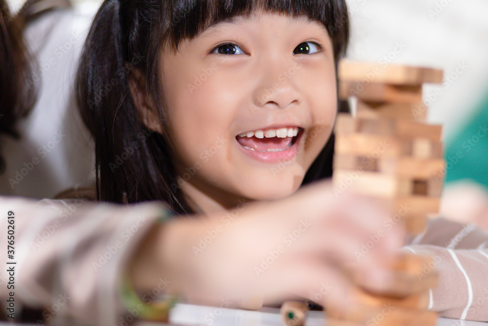 Happy asian family with daughter playing together the wooden blocks tower at home. Happy asian family with daughter playing together the wooden blocks tower at home.