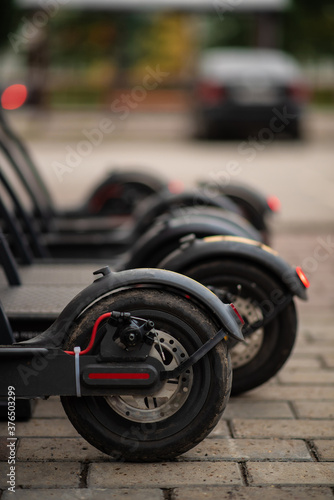 background of parking lot with electric scooters in urban environment