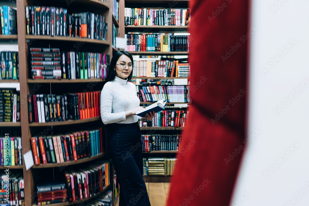 Asian young woman reading in library Asian young woman reading in library