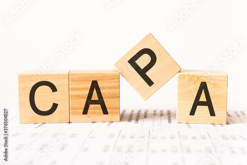 Word capa. Wooden small cubes with letters isolated on white background with copy space available