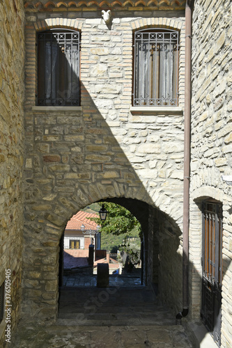 A narrow street among the old houses of Guardia Perticara, a rural village in the Basilicata region, Italy. photo